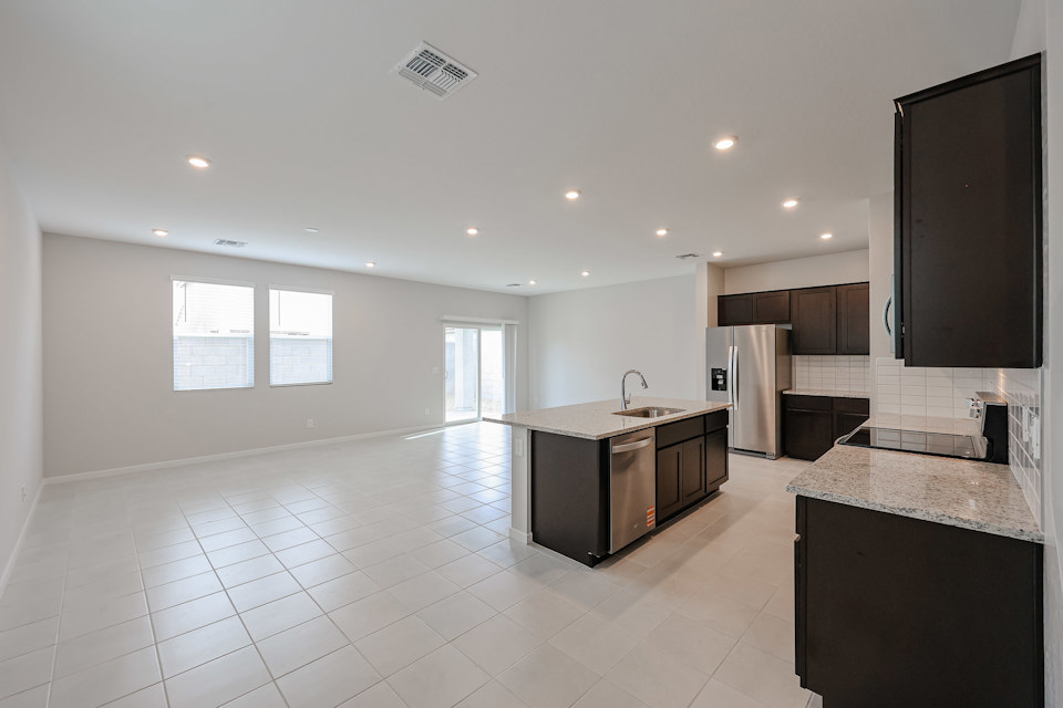 A kitchen with a large tile floor.