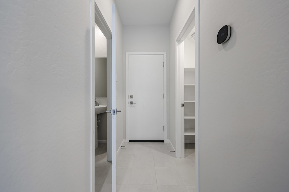 A hallway with white doors.