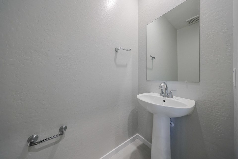 A bathroom with a sink and mirror.