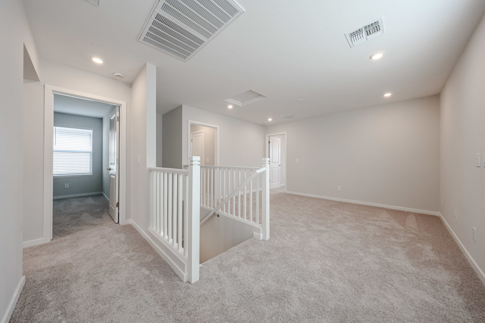 A room with a white railing and a white railing.