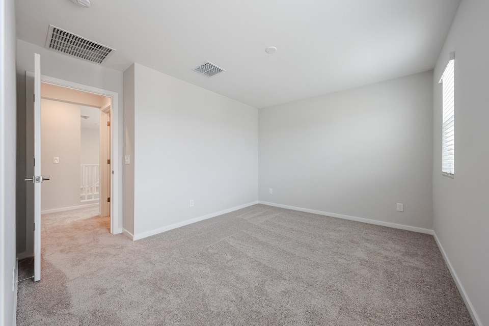 A room with carpet and a door.