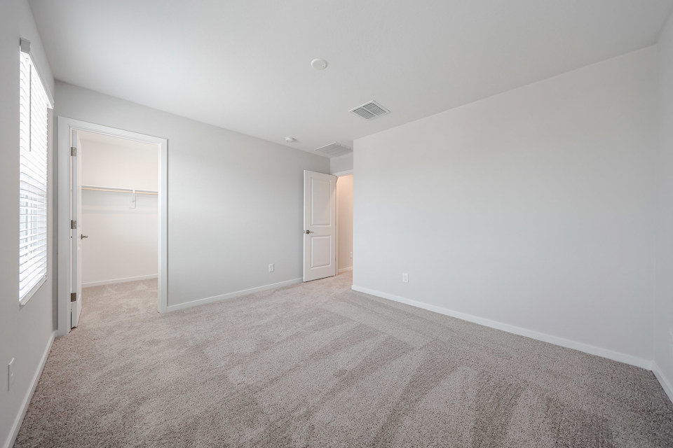 A long hallway with white doors.