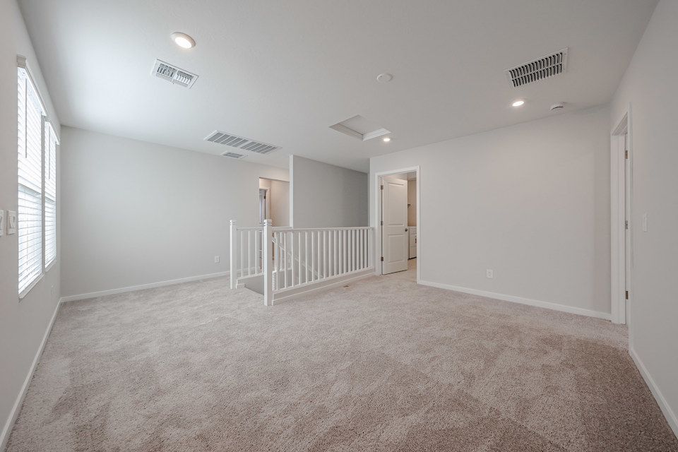 A room with a white railing and a white railing.