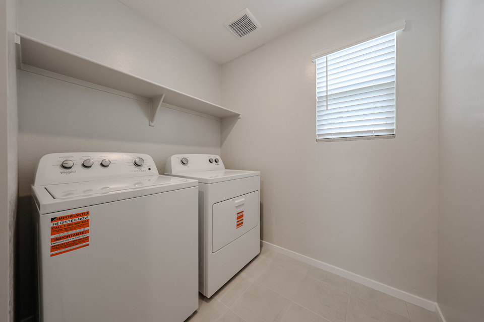 A washing machine and dryer in a room.