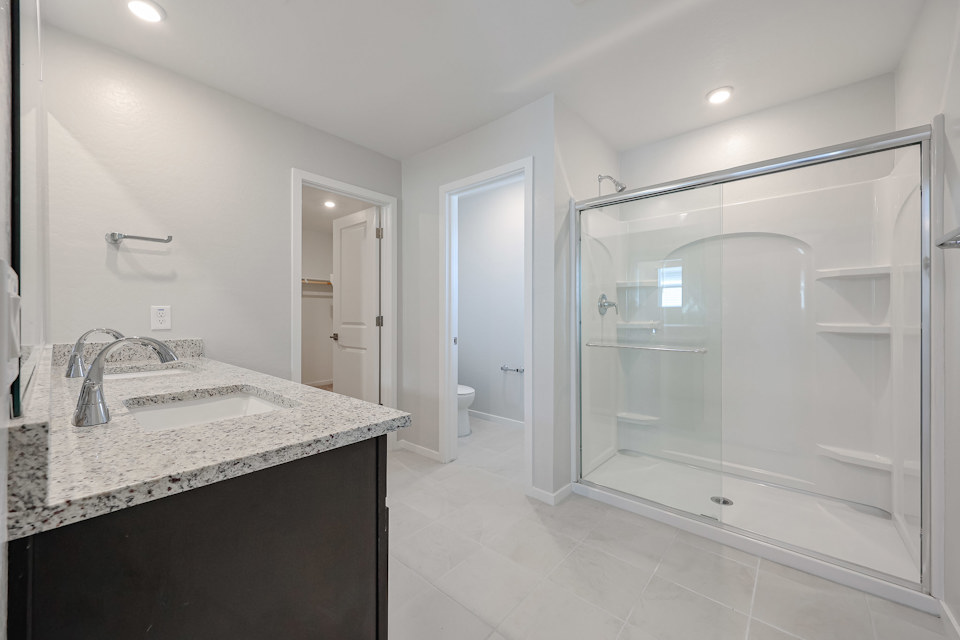 A bathroom with a bathtub and shower.