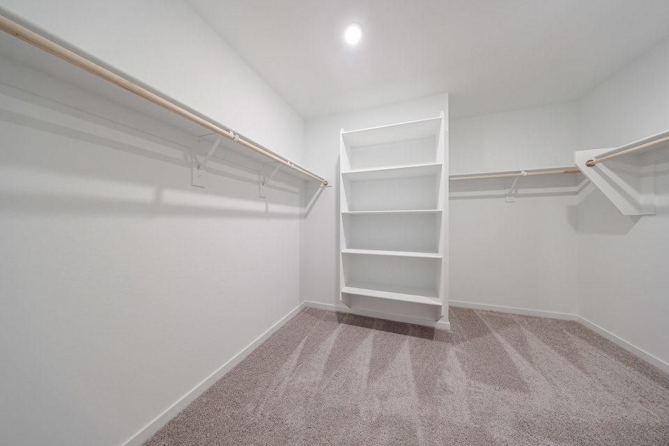 A white room with a white shelf.