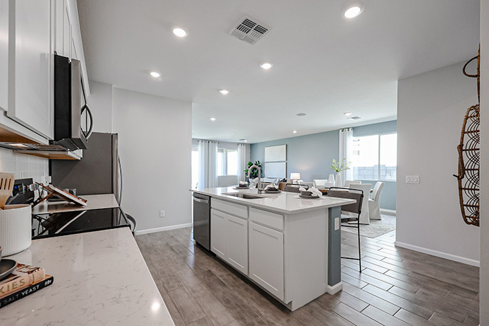 A kitchen with white cabinets.