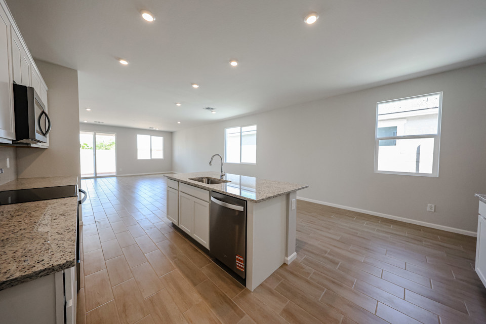 A kitchen with wooden floors.