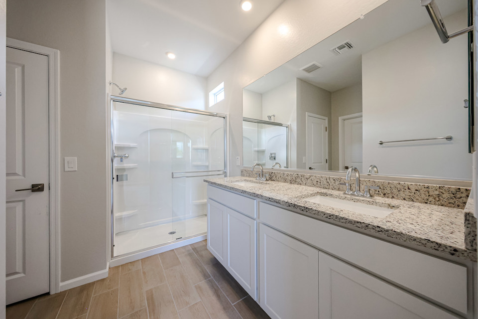 A bathroom with a large mirror.
