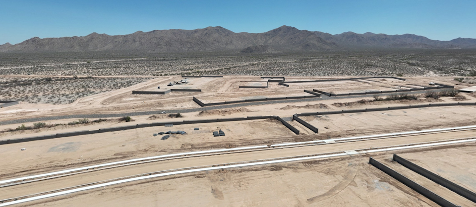A desert landscape with mountains in the background.