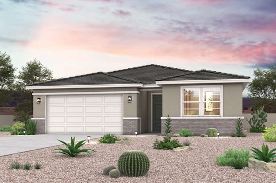 A house with a garage and bushes.