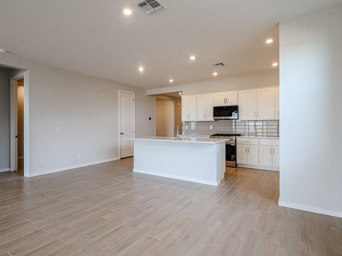 A kitchen with white cabinets.