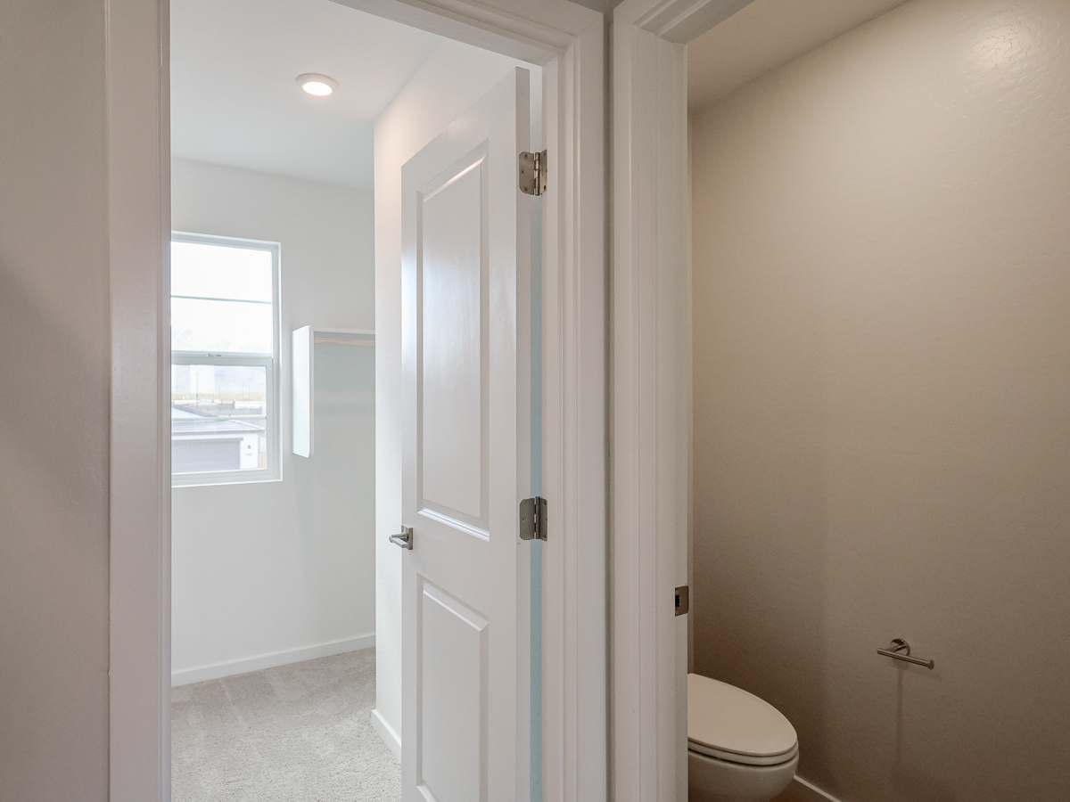 A bathroom with white doors.