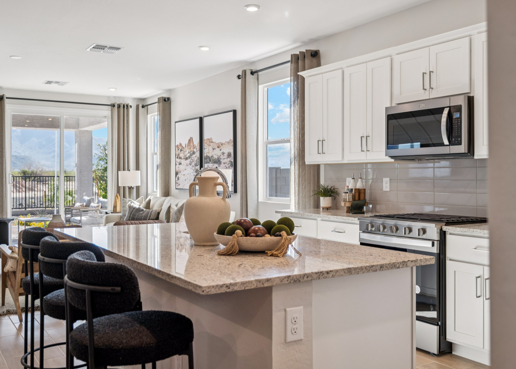 A kitchen with white cabinets.