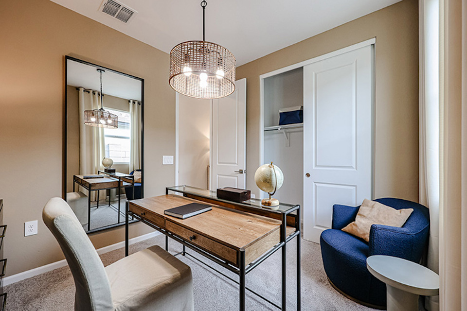 A living room with a table and chairs.