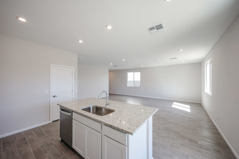 A kitchen with a marble countertop.