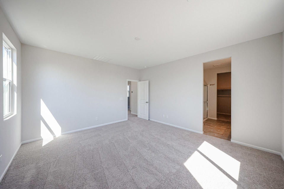 A room with a carpet and a door.