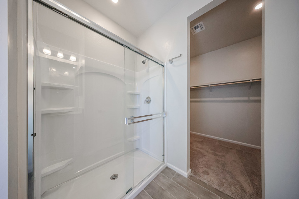 A shower with a glass door.