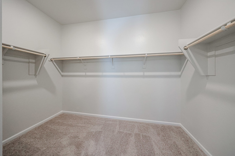 A white room with a metal railing.