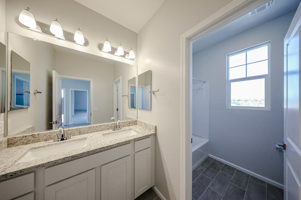 A bathroom with a marble countertop.