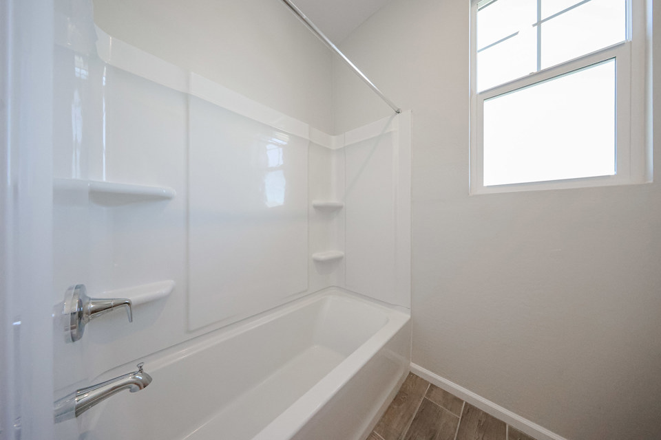 A bathroom with a bathtub and sink.