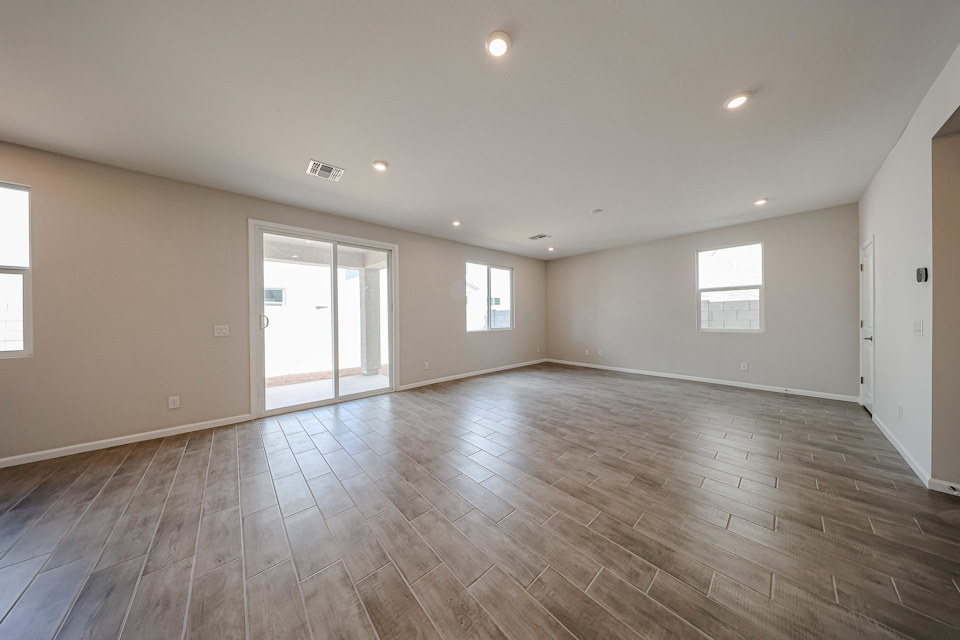 A room with a wood floor and windows.