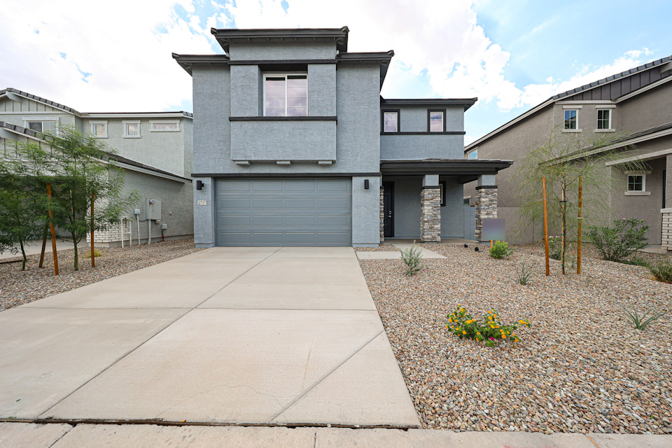 A driveway leading to a house.