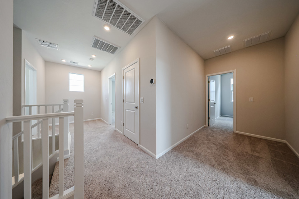 A hallway with white doors.