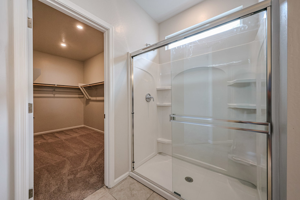A shower with a glass door.