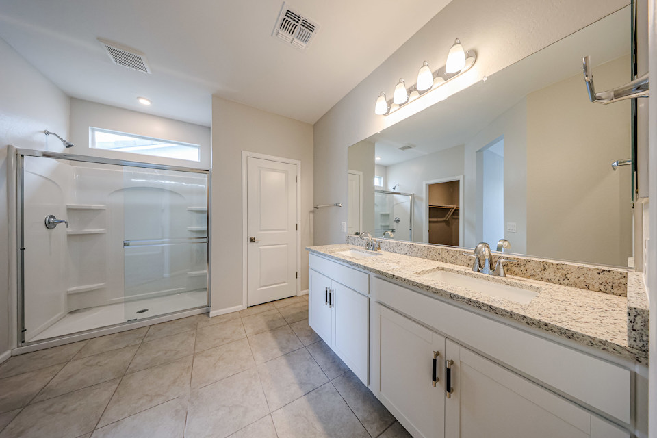 A bathroom with a marble countertop.