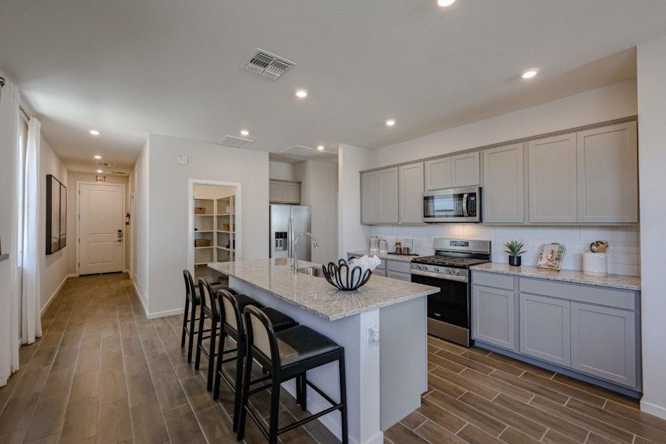 A kitchen with white cabinets.