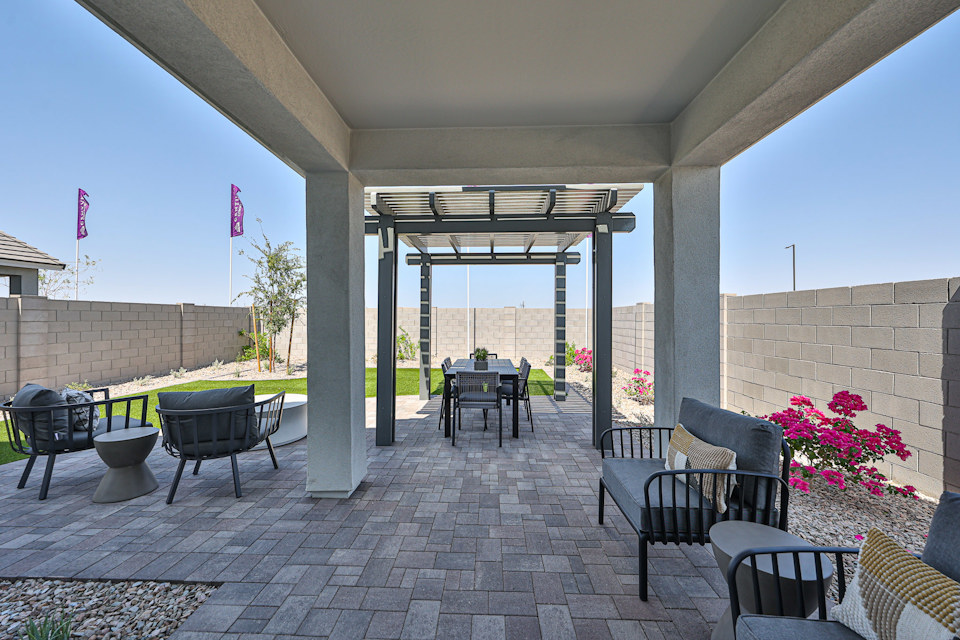 A patio with chairs and tables.