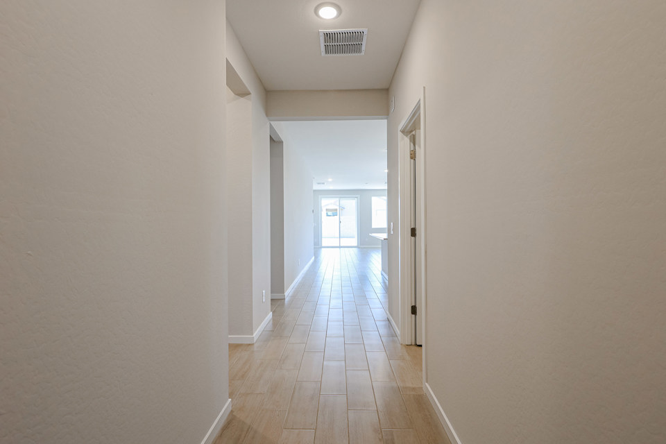 A long hallway with white walls.