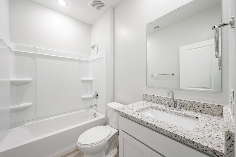 A bathroom with a marble countertop.