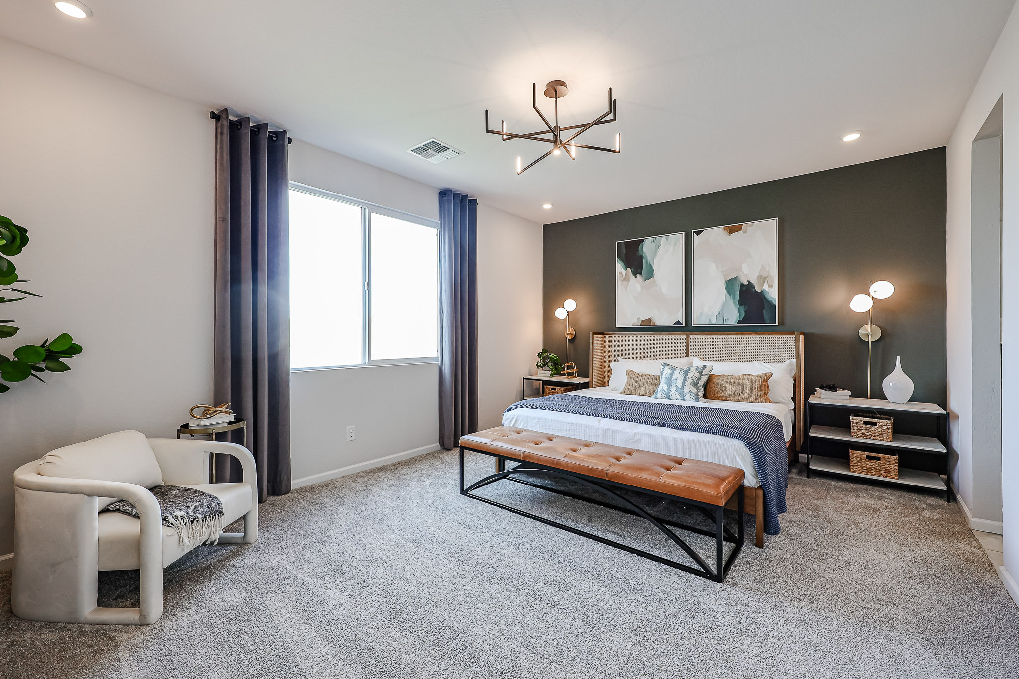 A bedroom with a bed and a chair.