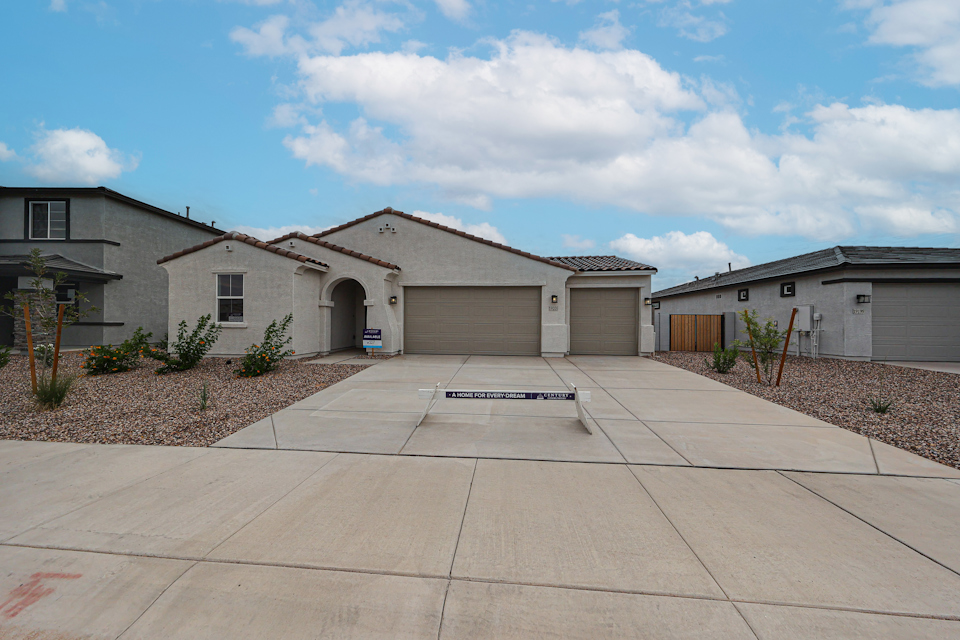 A driveway leading to a building.