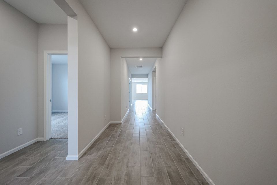 A hallway with white walls.