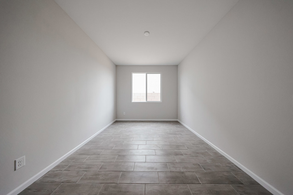 A room with a tile floor and a window.
