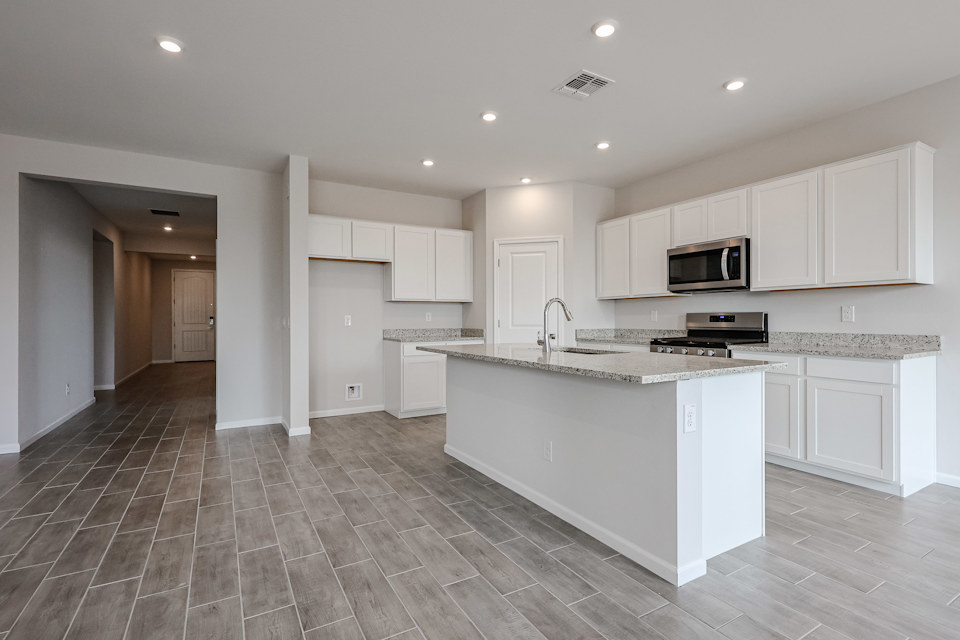 A kitchen with white cabinets.