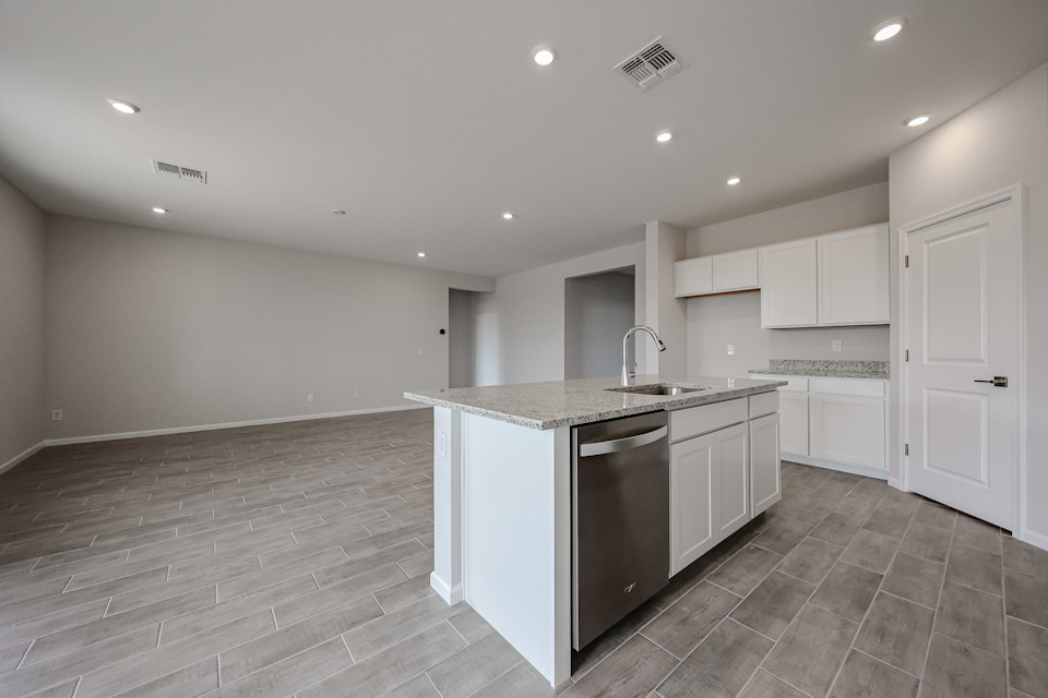 A kitchen with white cabinets.