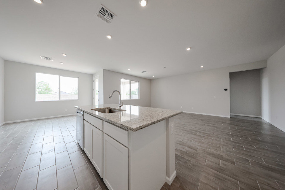 A kitchen with a marble countertop.