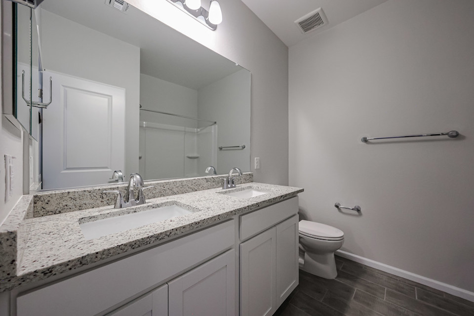 A bathroom with a large mirror.