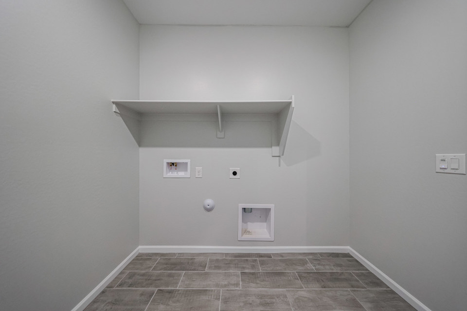 A white room with a tile floor.