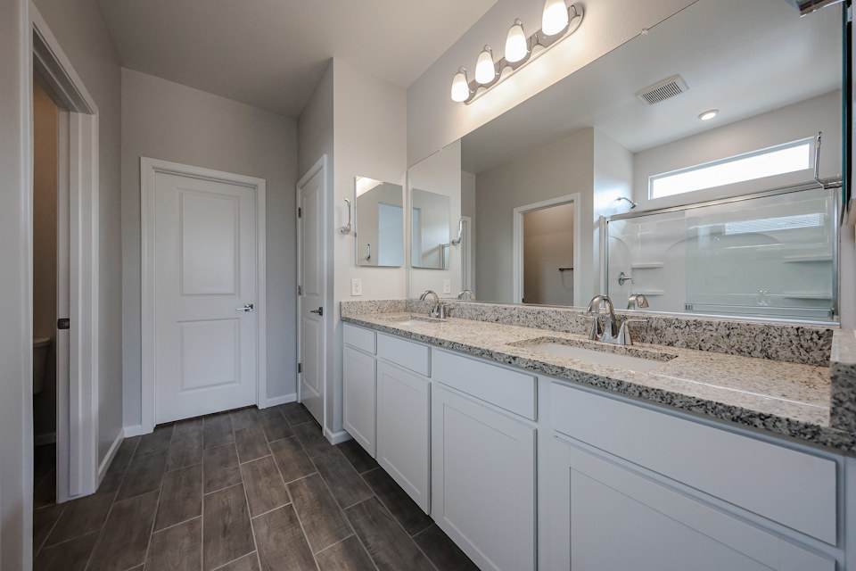A bathroom with a marble countertop.