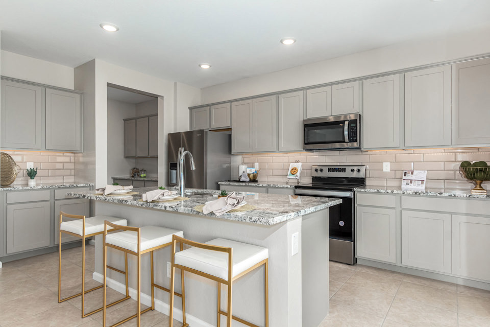 A kitchen with white cabinets.