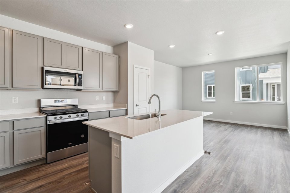 A kitchen with white cabinets.