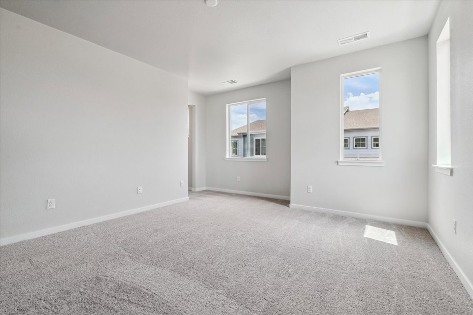 A room with a window and a carpet.