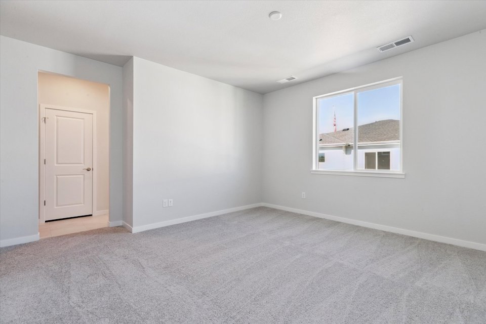 A room with a window and a door.