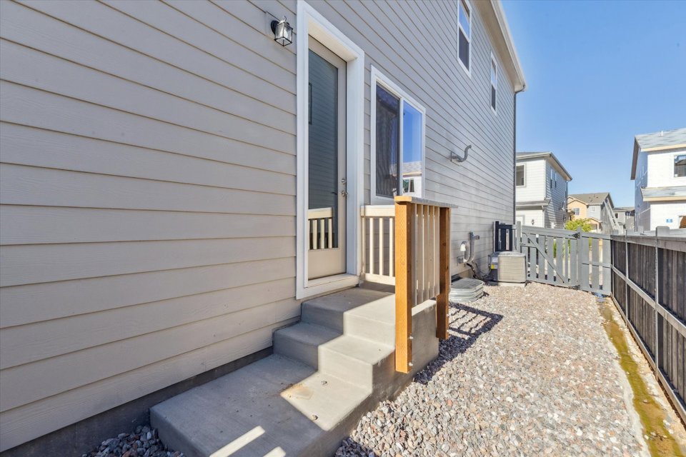 A house with a fence and a dirt path.