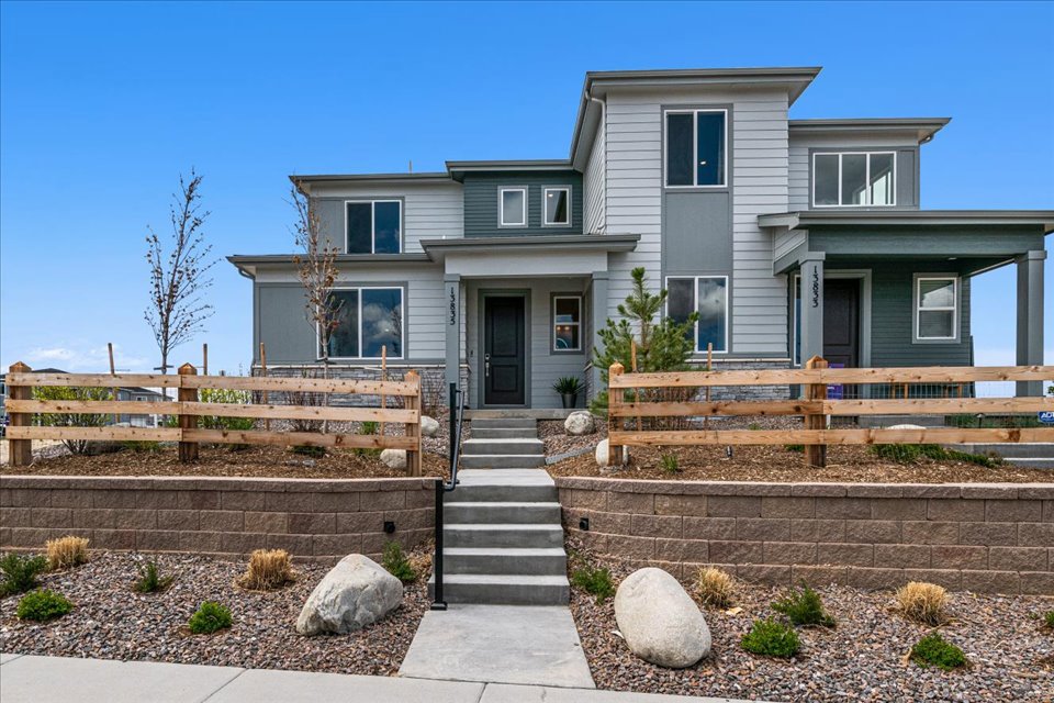 A house with a fence and stairs.